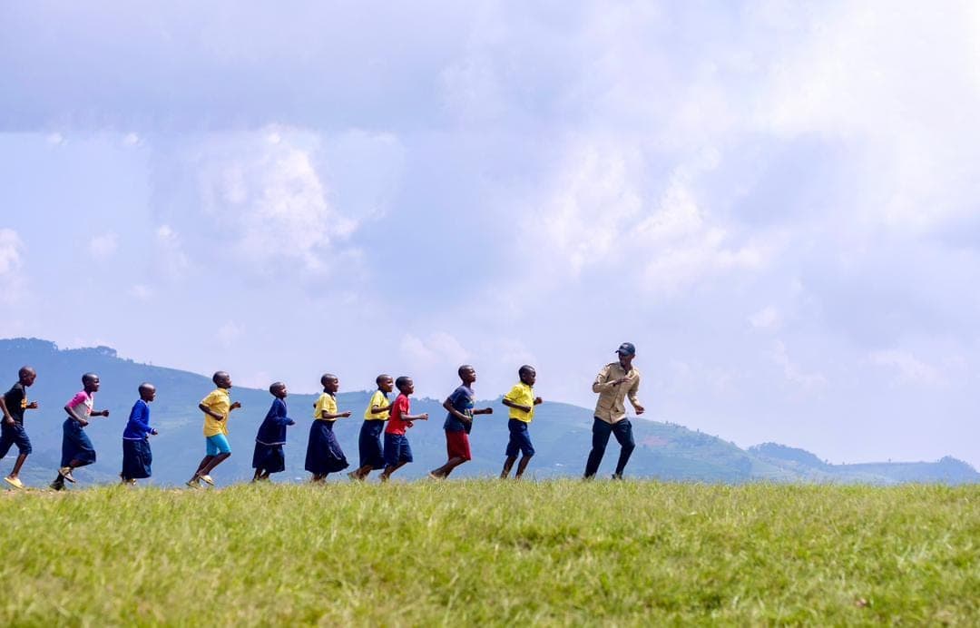 Children walking together across the Rwandan hills